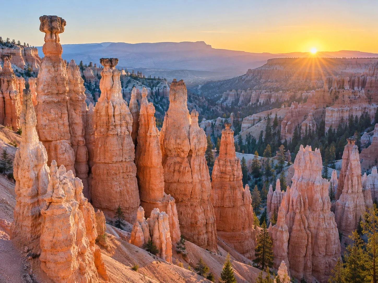 Warm coral and cream hoodoos rising across Bryce Canyon at sunrise